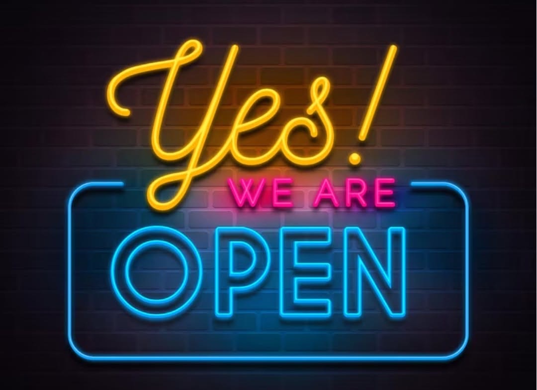 A neon sign reading YES! WE ARE OPEN