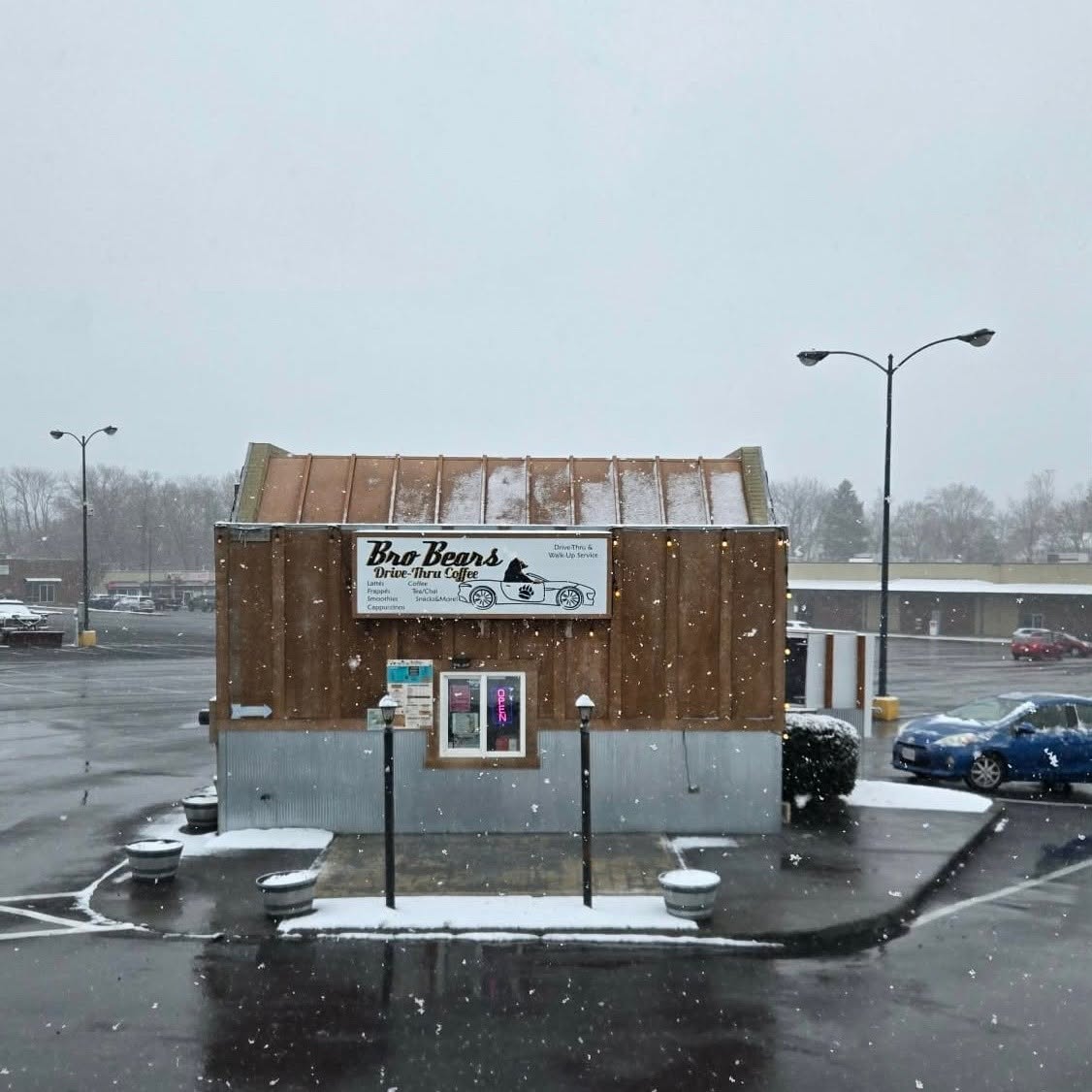A Bro Bears red-roof drive-thru coffee building under a blue sky