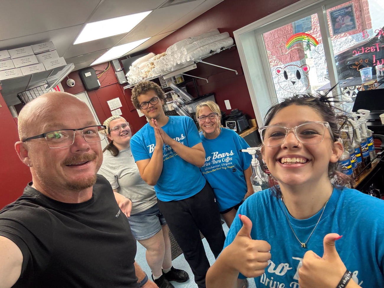 Bro Bears staff behind the counter giving a thumbs up