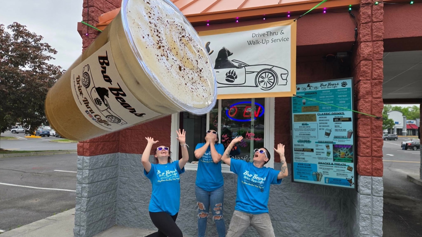 Bro Bears staff in branded shirts jumping and celebrating outside the store